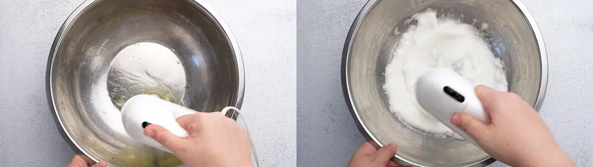 Hand holding electric hand-mixer in stainless steel bowl to beat egg whites.