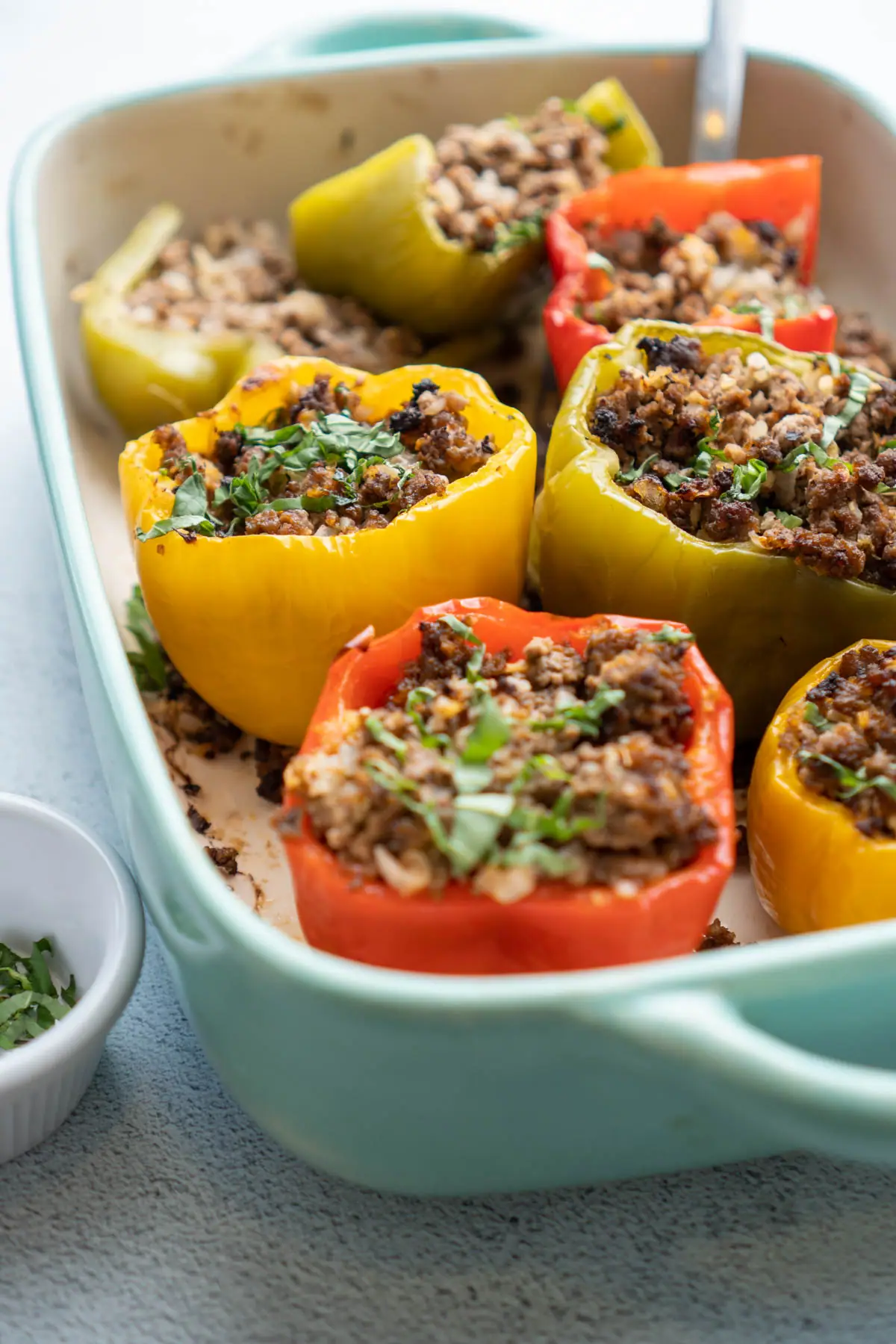 Casserole dish with keto stuffed peppers prepared from the recipe.